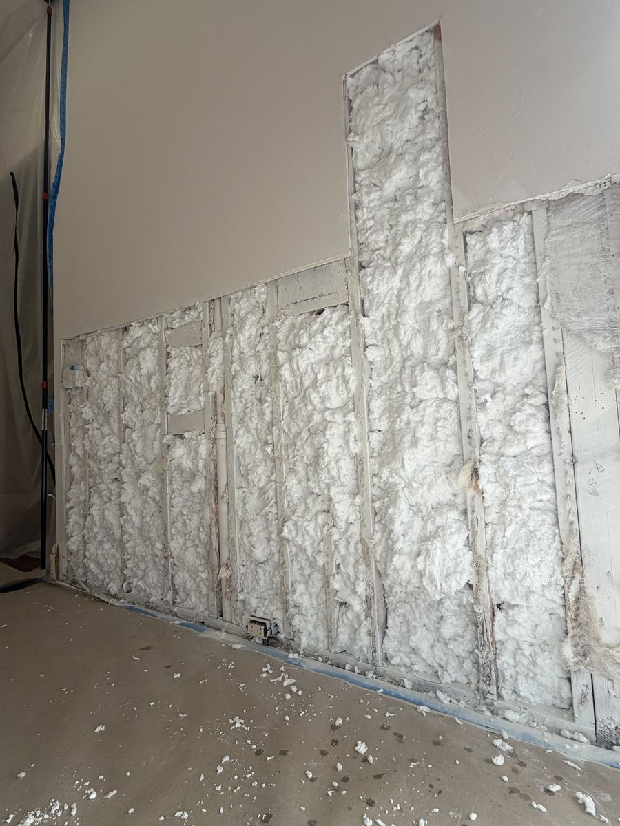 The same wall with every open cavity filled with new insulation, ready for drywall