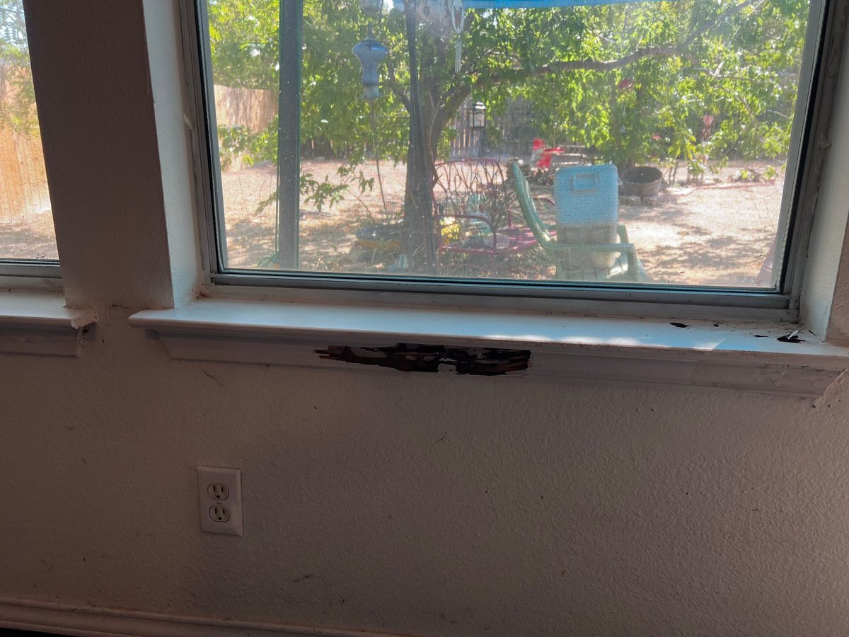 Window sill apron with rotted, broken-away wood from water damage